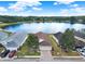 High angle view of home with two-car garage situated on a serene lake at 496 Lake Suzanne Dr, Lake Wales, FL 33859