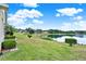 Backyard view of a lake surrounded by lush greenery, providing a serene and private outdoor space at 496 Lake Suzanne Dr, Lake Wales, FL 33859