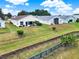 Backyard featuring serene water view, lush greenery, and a well-maintained lawn for outdoor enjoyment at 496 Lake Suzanne Dr, Lake Wales, FL 33859
