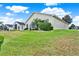 Spacious backyard featuring lush green grass, mature landscaping, and a peaceful view at 496 Lake Suzanne Dr, Lake Wales, FL 33859