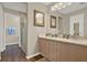 Bright bathroom with double vanity, decorative mirror and separate enclosed glass door shower at 496 Lake Suzanne Dr, Lake Wales, FL 33859