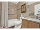 Bathroom with a tiled shower/tub combo with tile surround and decorative accents, plus a granite vanity at 496 Lake Suzanne Dr, Lake Wales, FL 33859