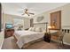 Cozy bedroom featuring a comfortable bed, ceiling fan, natural light, and decorative wall art at 496 Lake Suzanne Dr, Lake Wales, FL 33859