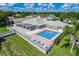 Aerial view of the community pool with lounge chairs, covered seating and manicured landscaping at 496 Lake Suzanne Dr, Lake Wales, FL 33859