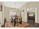 Inviting dining room with elegant chandelier and view into the study at 496 Lake Suzanne Dr, Lake Wales, FL 33859