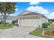 Well-maintained home featuring a two-car garage, a paved driveway, and manicured landscaping at 496 Lake Suzanne Dr, Lake Wales, FL 33859