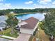 Aerial shot of home featuring manicured lawn, brick driveway, and inviting curb appeal at 496 Lake Suzanne Dr, Lake Wales, FL 33859
