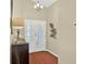 Bright foyer with decorative lighting, stylish console table, and elegant front door with glass detailing at 496 Lake Suzanne Dr, Lake Wales, FL 33859