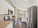 Charming kitchen featuring stainless steel appliances, white cabinets, and a vaulted ceiling at 496 Lake Suzanne Dr, Lake Wales, FL 33859