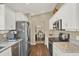 Bright kitchen boasts stainless steel appliances, granite countertops, and white cabinets at 496 Lake Suzanne Dr, Lake Wales, FL 33859