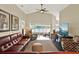 Bright living room with lake views, ceiling fan, a comfortable sectional sofa, and wood-look flooring at 496 Lake Suzanne Dr, Lake Wales, FL 33859