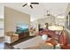 Open-concept living room with vaulted ceilings, multiple ceiling fans, neutral decor, and seamless flow to other spaces at 496 Lake Suzanne Dr, Lake Wales, FL 33859
