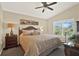 Calm and spacious main bedroom with vaulted ceiling and serene view from the window at 496 Lake Suzanne Dr, Lake Wales, FL 33859