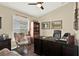 Spacious home study featuring a ceiling fan, built in book shelves, and a large desk at 496 Lake Suzanne Dr, Lake Wales, FL 33859