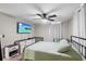 Comfortable bedroom featuring a bed, dresser, TV, and a calming atmosphere at 519 Sharon Hill Ct, Winter Haven, FL 33880