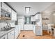 Open kitchen with white cabinetry, an island, and a view into the dining area at 519 Sharon Hill Ct, Winter Haven, FL 33880