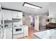 Functional kitchen featuring white appliances and cabinetry, and open layout at 519 Sharon Hill Ct, Winter Haven, FL 33880