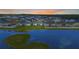 Expansive aerial shot showcasing a home situated near a scenic lake within a residential community at 5767 Lakeside Landings Blvd, Winter Haven, FL 33881