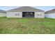 A spacious backyard with a covered lanai offers space for outdoor living and entertaining at 5767 Lakeside Landings Blvd, Winter Haven, FL 33881