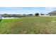 Spacious backyard with beautiful pond views in a residential neighborhood at 5767 Lakeside Landings Blvd, Winter Haven, FL 33881
