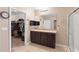 Bathroom features a double sink vanity, walk-in shower, and a walk-in closet at 5767 Lakeside Landings Blvd, Winter Haven, FL 33881