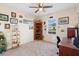 Comfortable bedroom with a window view, ceiling fan, and decorative corner shelf at 5767 Lakeside Landings Blvd, Winter Haven, FL 33881