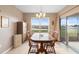 Dining room with a wooden table and chairs next to the screened-in lanai at 5767 Lakeside Landings Blvd, Winter Haven, FL 33881