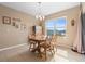 Dining area with a wood table, chairs, and a sliding door to the lanai at 5767 Lakeside Landings Blvd, Winter Haven, FL 33881