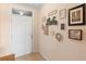 Inviting foyer featuring a white front door, tan walls, and decorative wall art at 5767 Lakeside Landings Blvd, Winter Haven, FL 33881