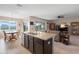 Kitchen island that opens up to the living room and dining area with lake view at 5767 Lakeside Landings Blvd, Winter Haven, FL 33881