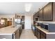 Kitchen with a large island, dark cabinets, and stainless steel appliances at 5767 Lakeside Landings Blvd, Winter Haven, FL 33881