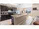 Kitchen featuring an island, dark cabinets, and stainless steel appliances at 5767 Lakeside Landings Blvd, Winter Haven, FL 33881