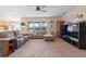 Comfortable living room with a ceiling fan and a large window view to the backyard at 5767 Lakeside Landings Blvd, Winter Haven, FL 33881