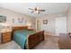 Bright main bedroom with ceiling fan, dresser, and window offering relaxing views at 5767 Lakeside Landings Blvd, Winter Haven, FL 33881