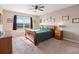 Serene main bedroom with a large window, ceiling fan, and comfortable furnishings at 5767 Lakeside Landings Blvd, Winter Haven, FL 33881