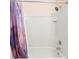 Clean shower space featuring white tiles, a shower head, and a stylish purple curtain at 5767 Lakeside Landings Blvd, Winter Haven, FL 33881