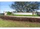 A community entrance sign with stone pillars and lush landscaping, welcoming residents and visitors at 5767 Lakeside Landings Blvd, Winter Haven, FL 33881