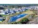 Aerial view of homes in a peaceful community with a scenic pond at 578 Preserve Pointe Blvd, Davenport, FL 33837