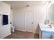 Modern bathroom with double sinks, wood-look flooring, a toilet, and white door at 578 Preserve Pointe Blvd, Davenport, FL 33837