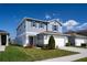 Charming two-story home with blue siding, a two-car garage, and a neatly landscaped front yard at 578 Preserve Pointe Blvd, Davenport, FL 33837