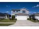 Well-maintained two-story home boasts curb appeal with blue siding, coordinated shutters, and a spacious two-car garage at 578 Preserve Pointe Blvd, Davenport, FL 33837