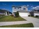 Attractive two-story home with a well-kept lawn, featuring blue siding, shutters, and a two-car garage at 578 Preserve Pointe Blvd, Davenport, FL 33837