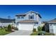 Two-story home featuring blue siding, a two-car garage, and a well-maintained front lawn at 578 Preserve Pointe Blvd, Davenport, FL 33837