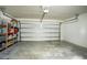 View of spacious garage with a garage door, concrete flooring, and storage on the sides at 578 Preserve Pointe Blvd, Davenport, FL 33837