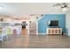 Open-concept living room showcasing wood-look floors and an accent wall at 578 Preserve Pointe Blvd, Davenport, FL 33837