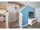 Bright living area with a staircase featuring neutral-colored carpeted steps at 578 Preserve Pointe Blvd, Davenport, FL 33837
