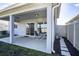 Back covered patio with table and chairs, view of backyard at 578 Preserve Pointe Blvd, Davenport, FL 33837