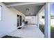 Covered patio featuring a table, chairs, and sliding glass doors to the interior of the home at 578 Preserve Pointe Blvd, Davenport, FL 33837