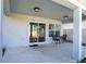 View of patio with dark table and chairs looking to lawn and backyard through sliding door at 578 Preserve Pointe Blvd, Davenport, FL 33837
