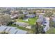 Aerial view of a community offering a swimming pool, tennis court, and well-maintained green spaces at 5850 Cypress Gardens Blvd # 206, Winter Haven, FL 33884